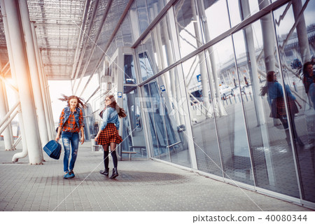 Girls having fun and happy when they met at the airport.Art proc 40080344
