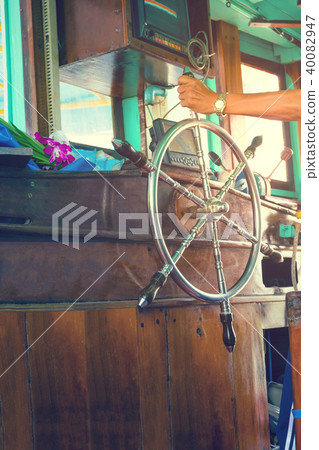 Hand holding steering wheel the fishing boat 40082947