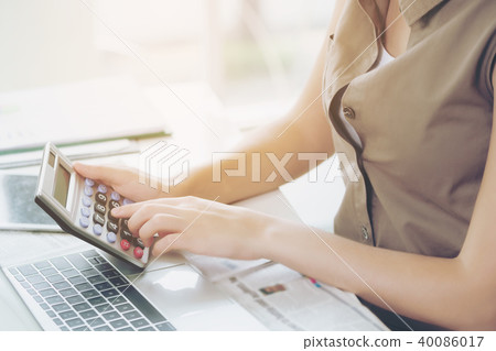 Business woman using calculator in the office. Business woman using calculator in the office. 40086017