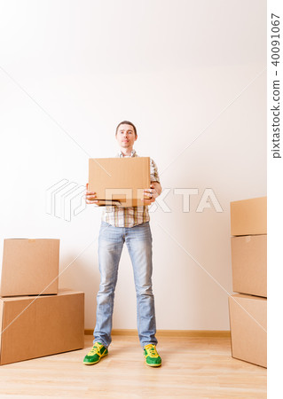 Photo of man standing among cardboard boxes Photo of man standing among cardboard boxes 40091067