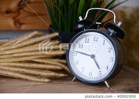 Retro Alarm Clock on wooden desk 40092008