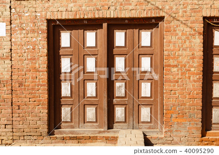 Wooden carved doors of an old house, Nepal Wooden carved doors of an old house, Nepal 40095290
