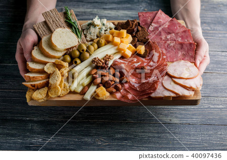 Assorted from meat and cheese on a chopping board Assorted from meat and cheese on a chopping board 40097436