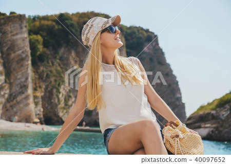 beautiful girl walking along the seashore in the summer day beautiful girl walking along the seashore in the summer day 40097652