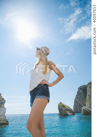 beautiful girl walking along the seashore in the summer day 40097653