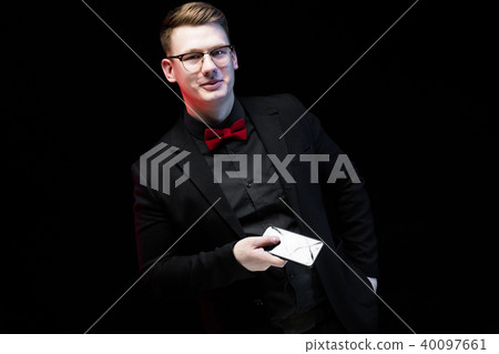 Portrait of confident handsome ambitious happy elegant responsible businessman offering mobile phone Portrait of confident handsome ambitious happy elegant responsible businessman offering mobile phone 40097661