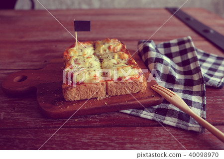 Pizza toasted bread with tomato sauce ham cheese Pizza toasted bread with tomato sauce ham cheese 40098970