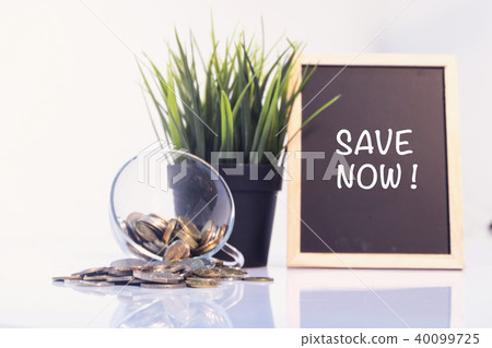 chalkboard with word SAVE NOW on reflection table. chalkboard with word SAVE NOW on reflection table. 40099725
