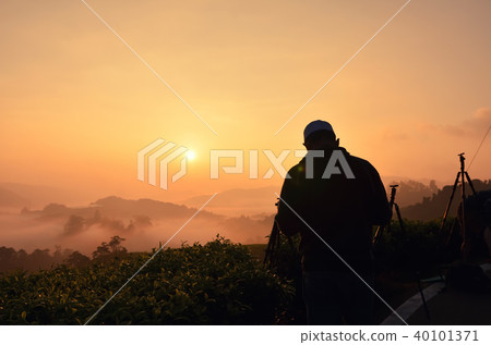silhouette of man standing over sunrise background silhouette of man standing over sunrise background 40101371
