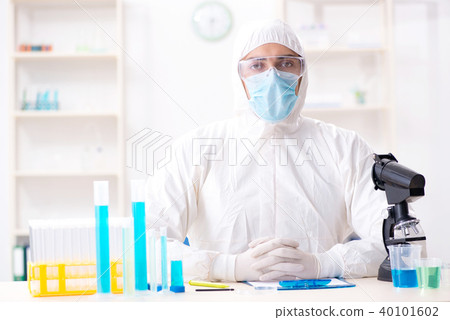 Young chemist student working in lab on chemicals Young chemist student working in lab on chemicals 40101602