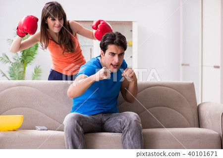 Wife unhappy that husband is watching boxing Wife unhappy that husband is watching boxing 40101671