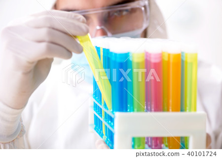 Young chemist student working in lab on chemicals 40101724