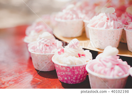 Pink cup cakes in wedding ceremony Pink cup cakes in wedding ceremony 40102198