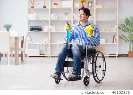 Disabled man on wheelchair cleaning home Disabled man on wheelchair cleaning home 40102336