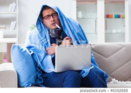 Sick businessman working from home due to flu sickness Sick businessman working from home due to flu sickness 40102680