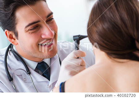 Doctor checking patients ear during medical examination Doctor checking patients ear during medical examination 40102720