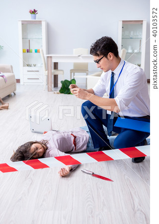 Forensic investigator at the crime scene investigating woman mur Forensic investigator at the crime scene investigating woman mur 40103572