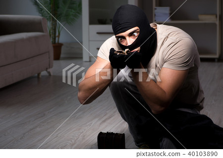 Burglar wearing balaclava mask at crime scene 40103890