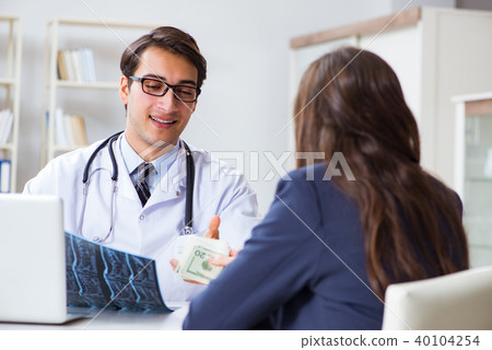 Doctor in corruption concept with being offered bribe 40104254