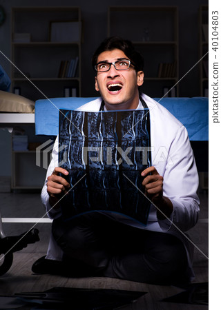 Doctor working night shift in hospital after long hours 40104803