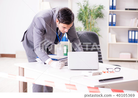 Forensics investigator at the scene of office crime 40105369