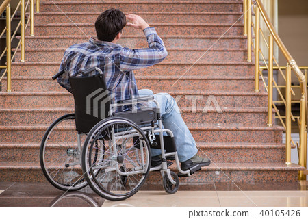 Disabled man on wheelchair having trouble with stairs Disabled man on wheelchair having trouble with stairs 40105426