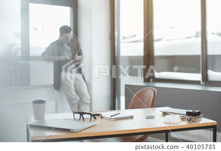 Concentrated man typing in mobile Concentrated man typing in mobile 40105785