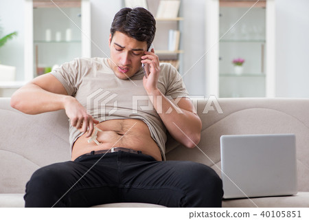 Man measuring body fat with calipers 40105851