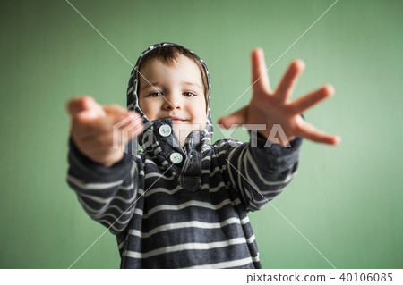 joyful smiling boy posing with arms stretched out in welcome gesture. 40106085
