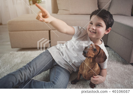Dreamful child having fun with his puppy 40106087