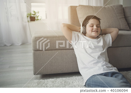 Cheerful boy listening favorite song from earphones Cheerful boy listening favorite song from earphones 40106094