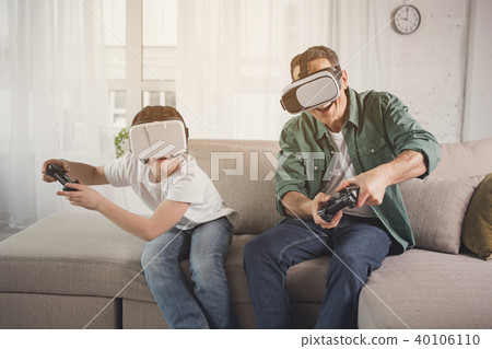 Happy father and son playing video game Happy father and son playing video game 40106110