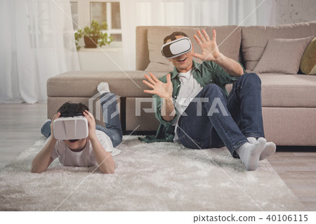 Excited parent and child having fun with vr devices Excited parent and child having fun with vr devices 40106115