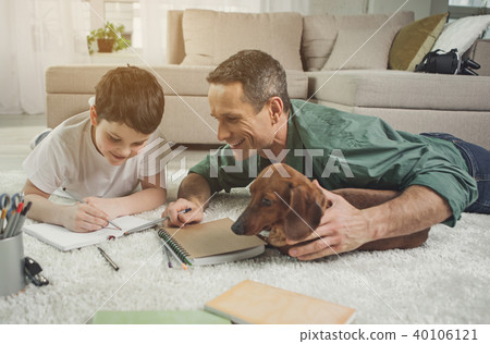 Happy father teaching boy maths at home 40106121