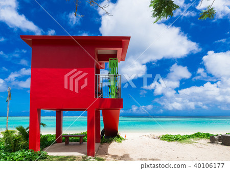 Tropical beach and red guard platform Guam 40106177
