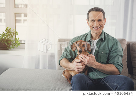 Positive owner and dog having fun at home 40106484