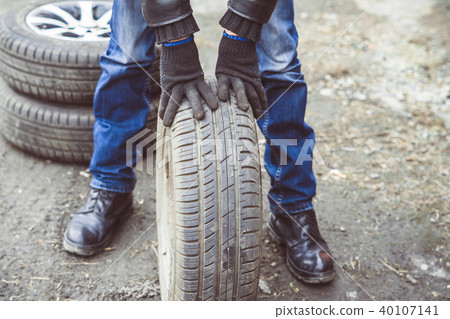 man changing wheel on a car man changing wheel on a car 40107141