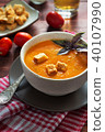 Bowl of tomato soup with basil and toasts 40107990