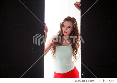 Portrait of fashionable girl in red pants on a black background 40108788