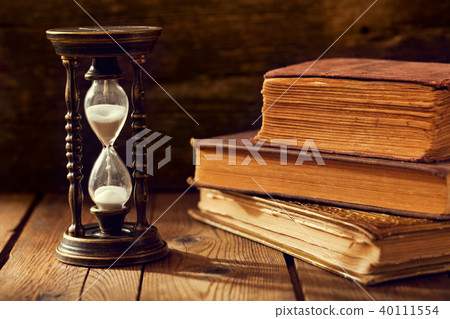 old hourglass with books old hourglass with books 40111554