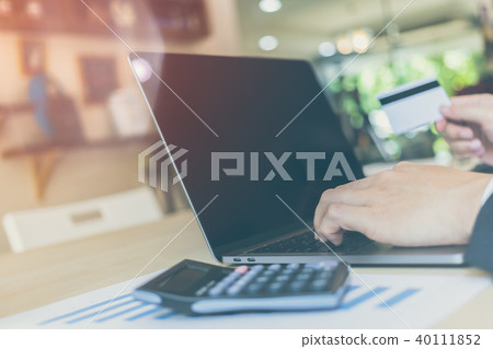 businessman hands holding credit card on computer 40111852