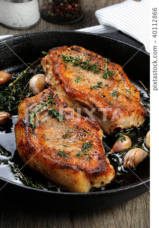 Roasted pork steak in frying pan 40112866