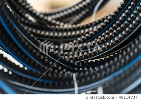 Closeup old timing belts. Rubber spare parts Closeup old timing belts. Rubber spare parts 40114737