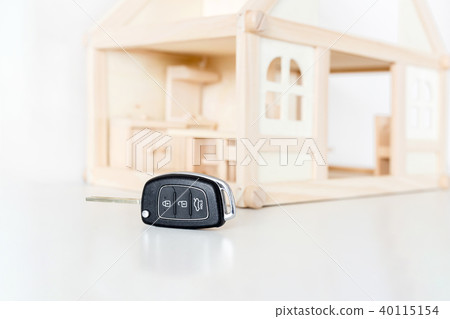 Car keys with wooden house model on background 40115154