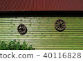Two ancient wooden wheels on wall of wooden house 40116828