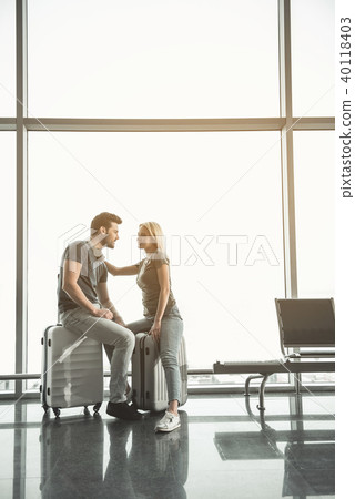 Cheerful female speaking with positive lady on luggage Cheerful female speaking with positive lady on luggage 40118403