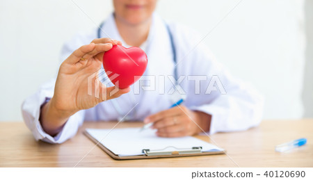 Portrait of woman doctor with holding red heart 40120690