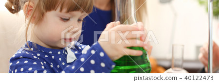 Woman and little girl play with colourful liquids Woman and little girl play with colourful liquids 40122473