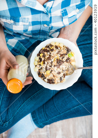 Girl with a plate of muesli Girl with a plate of muesli 40123919