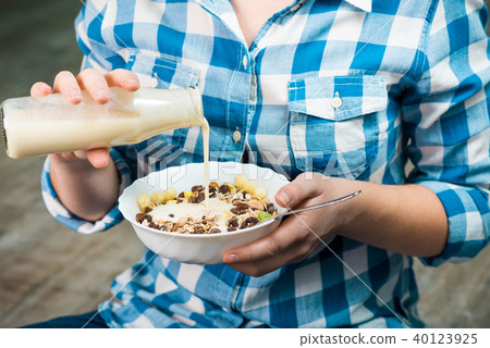 Girl with a plate of muesli Girl with a plate of muesli 40123925
